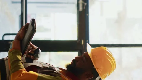 Vertical video: Warehouse employee scanning barcodes on products Stock Footage 232546031