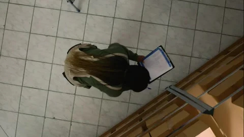 Vertical video Warehouse supervisor examines parcels 스톡 동영상 251234666