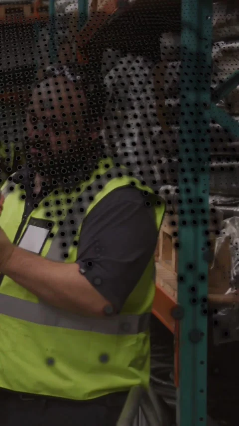 Vertical video: Warehouse tech using scanner scanning racks via clear screen Stock Footage 334604602