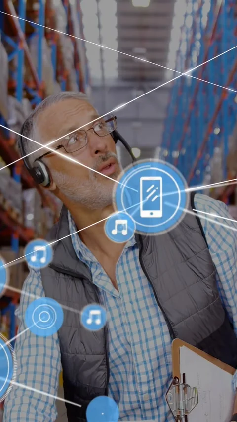 Vertical video: Warehouse worker checking laptop and entering data, visualizing Stock Footage 329961758