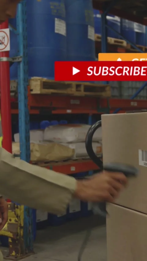 Vertical video: Warehouse worker grabbing wired scanner scanning boxes checking Stock Footage 333835982