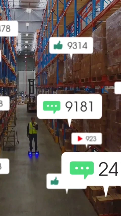 Vertical video: Warehouse worker starting scooter down aisle while monitoring Video stock 333836206