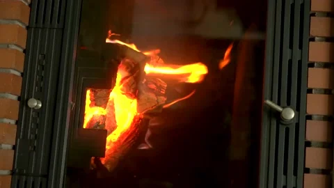 Vertical video: warm cozy fireplace with wood during a cold day at home. Wint Stock Footage 168072453