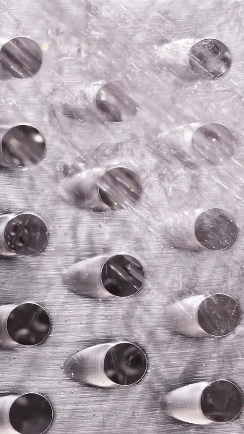 Vertical video. Water Flow and Soap Foam Moving Across Metal Grater Surface, Mac Stock Footage 334229873