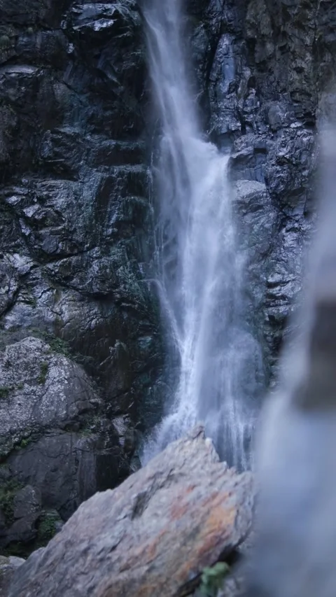 Vertical video. Waterfall. Mountain river with rapids. Wet rocks, splashes and f Stock Footage 162156230
