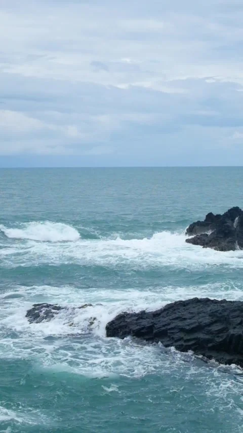 Vertical video of waves gently crashing against the reef Stock Footage 319845671
