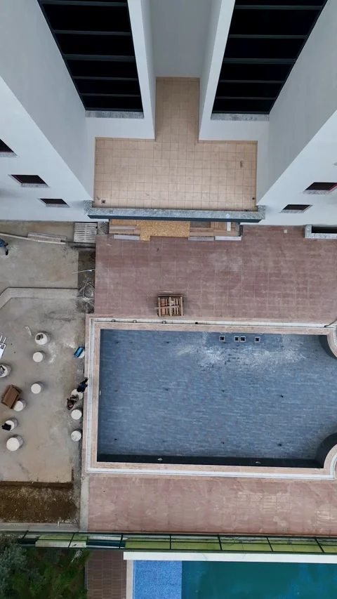 Vertical Video: Weathering the Elements - Summer Pool Construction Journey Stock Footage 243831720