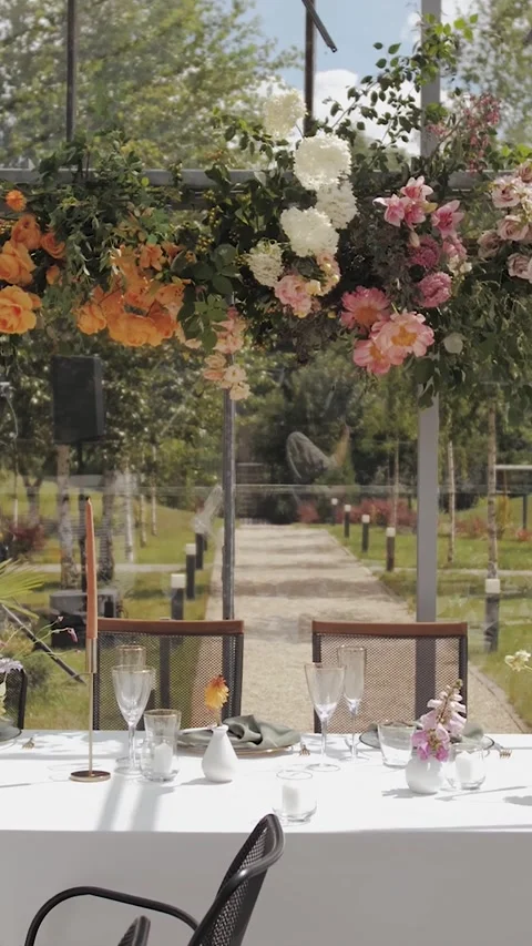 Vertical video. Wedding table in a greenhouse. Wedding decor on a white table Stock Footage 307922157