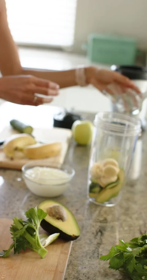 Vertical video: When celery chopping ends, arms are stacking avocado, yogurt, Stock Footage 345321104