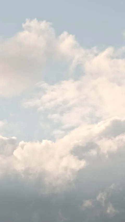 Vertical video, White fluffy clouds fly against blue sunny sky background Stock Footage 307282522