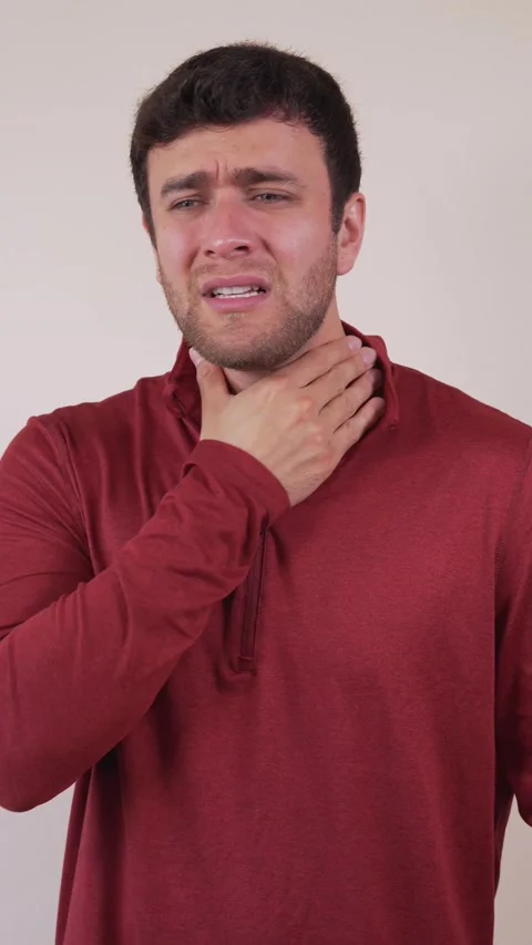 Vertical video of a white man with a sore throat, expression of anguish and.. Stock Footage 236678176