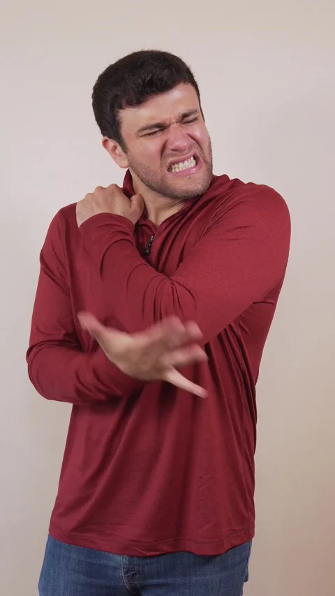 Vertical video of a white man with a strong pain in his elbow, due to a str.. Stock Footage 236678206