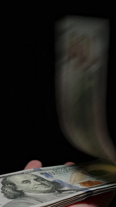 Vertical video. A Whole Stack Of Dollars Flying Away From Hands In The Wind And Stock Footage 277584167