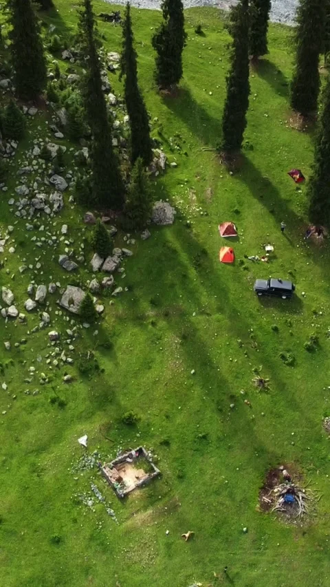 Vertical video: Wilderness Base Camp with Tents and SUV Aerial Stock Footage 331993073