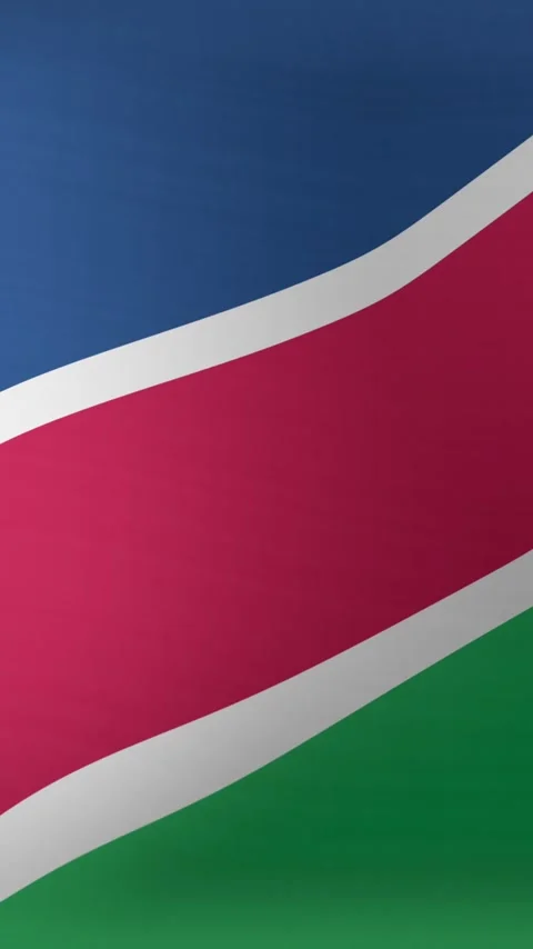 Vertical video: Wind starting motion, Namibian flag rippling and curving Stock Footage 348567863