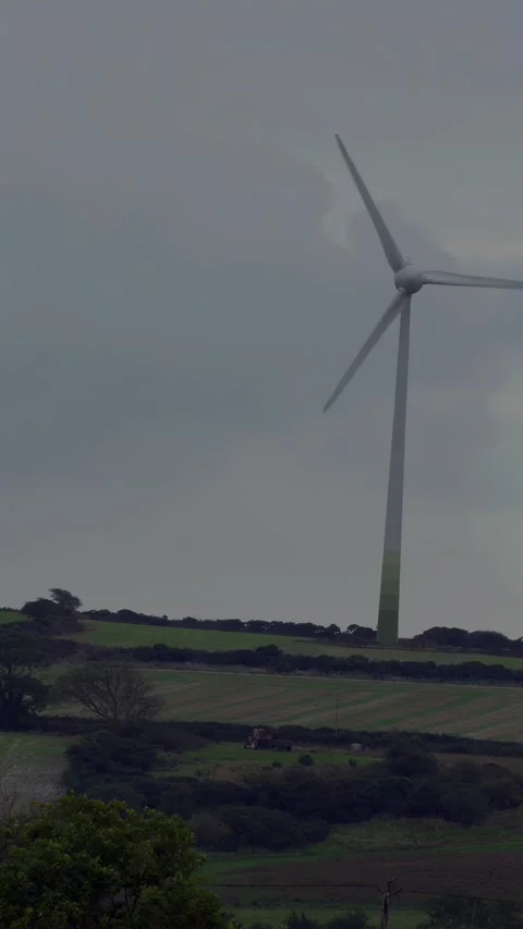 Vertical video: Wind turbine rotating while green AR overlay growing on data Stock Footage 333513527
