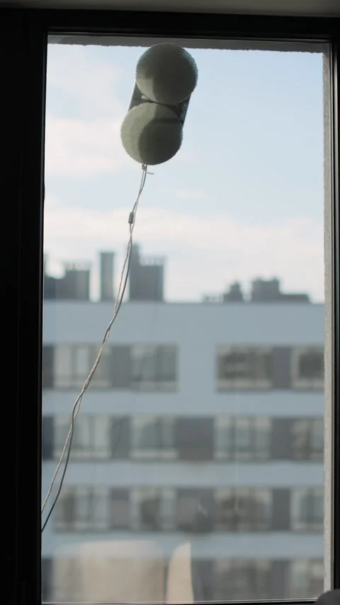 Vertical video of Window cleaning robot in action on glass, modern smart home Video stock 320078070