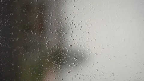 Vertical Video of a Window whit Raindrops Flowing Down Stock Footage 194531868