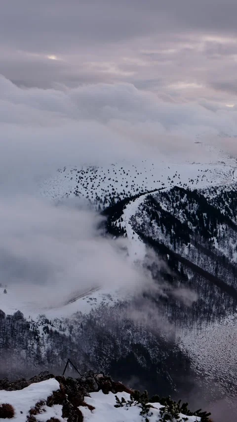Vertical video ,Winter Cloud Inversion Timelapse over Snowy Mountain Ridges 動画素材 327594363