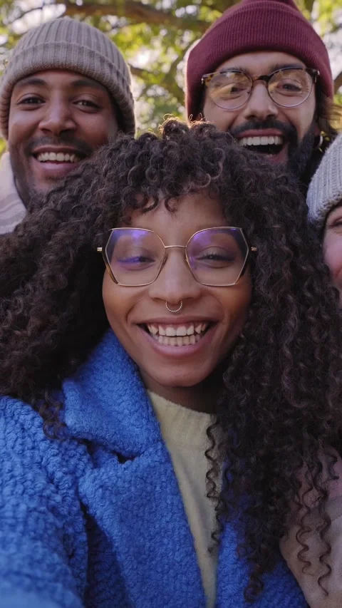 Vertical video. Winter time smiling selfie of a happy group of multicultural Stock Footage 229862405
