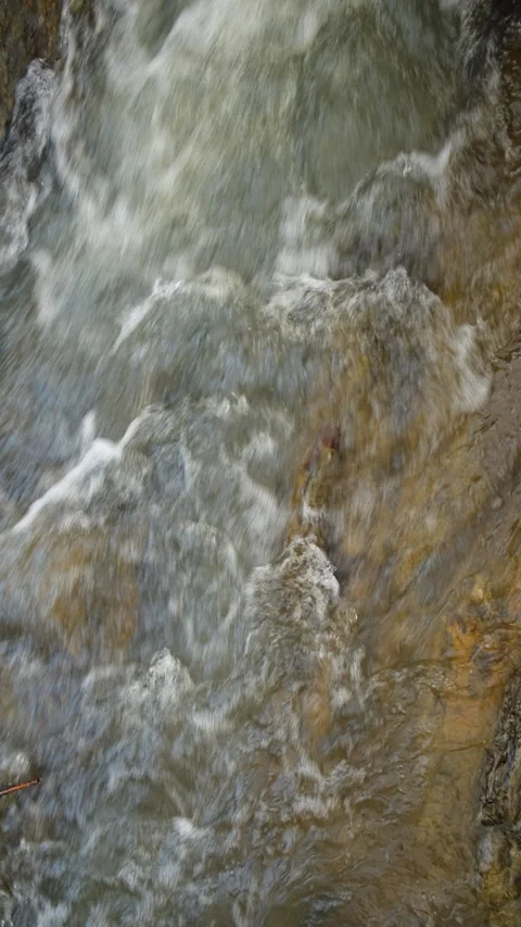 Vertical video of winter waterfall river close up. Crystal water in mountains Stock Footage 299703736