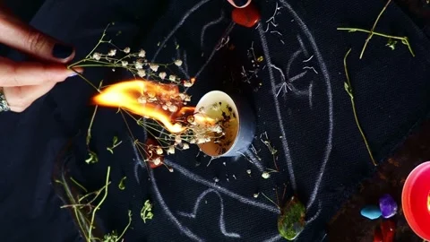 Vertical video, Witch hands burning herbs for a black magic ritual Video stock 248087730