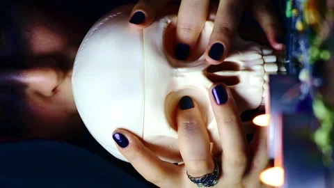 Vertical video, Witch hands holding and kissing a scary skull Stock Footage 248088757