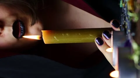 Vertical video, Witch hands performing a magic ritual blowing off a candle Stock Footage 248089209