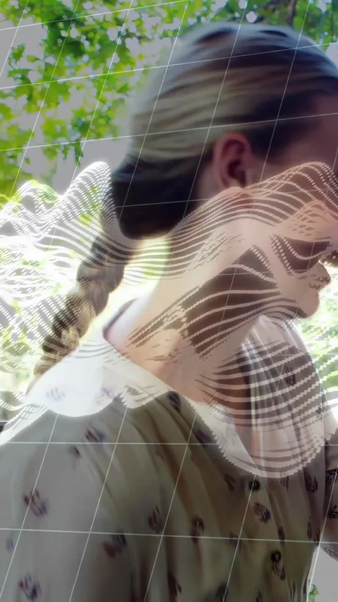 Vertical video: Woman with braid reaching phone, grid overlay crossing face Stock Footage 334602383