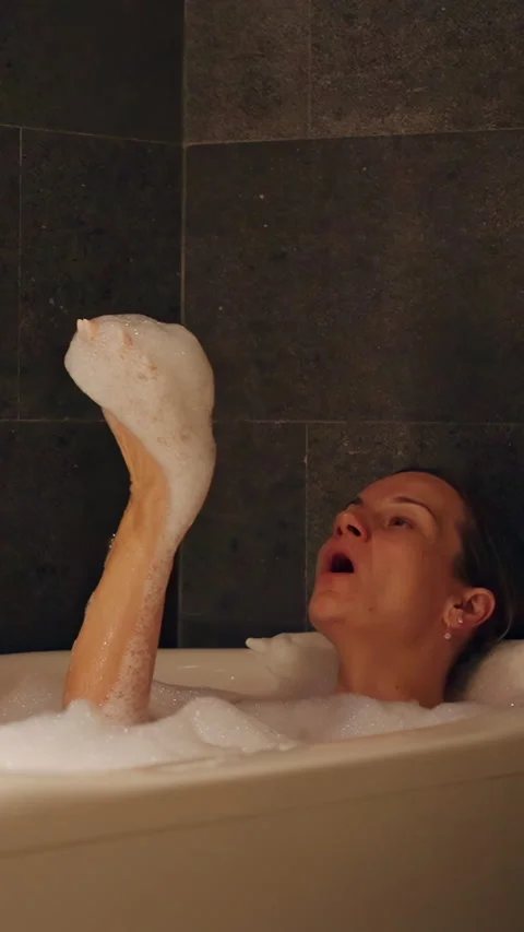 Vertical video. Woman in Bubble Bath Throwing Foam Upward with Slow Motion Effec Stock Footage 323634300