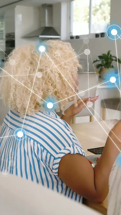 Vertical video: Woman clapping at table, animating node network and showing home Stock Footage 337540483