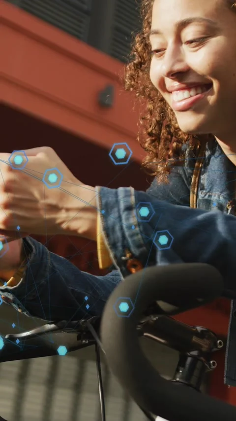 Vertical video: Woman commuting tapping phone on bike bars, AR hexagons Stock Footage 333745754