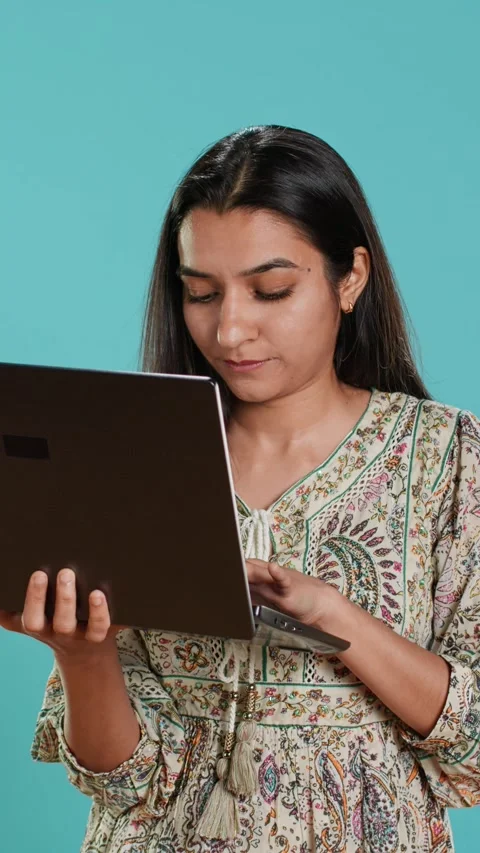 Vertical video Woman composing email, carefully typing on laptop keyboard Stock Footage 275097751