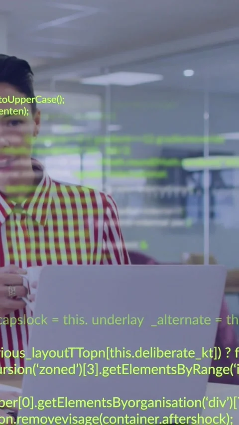 Vertical video: Woman developer typing at laptop, activating green code overlay Video stock 334382332