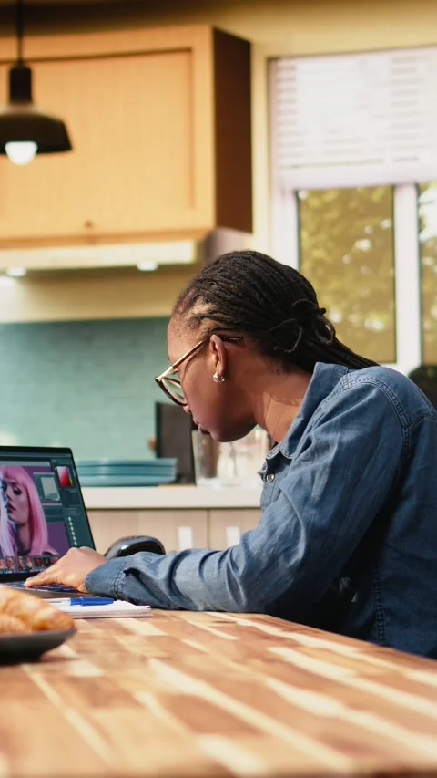 Vertical Video Woman editor working on photograph on laptop for post production Stock Footage 344529678