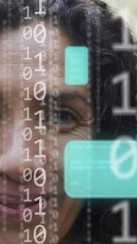 Vertical video: Woman facing binary flow from right moving teal UI over face Stock Footage 333236281