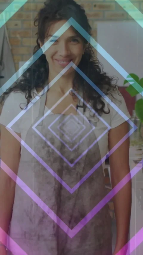 Vertical video: Woman hosting in kitchen, diamond overlay shifting causing smile Stock Footage 334319207