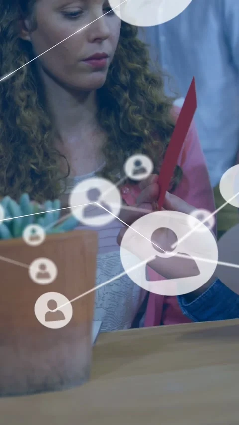 Vertical video: Woman marking note, causing IT network map on table for review Stock Footage 332546801