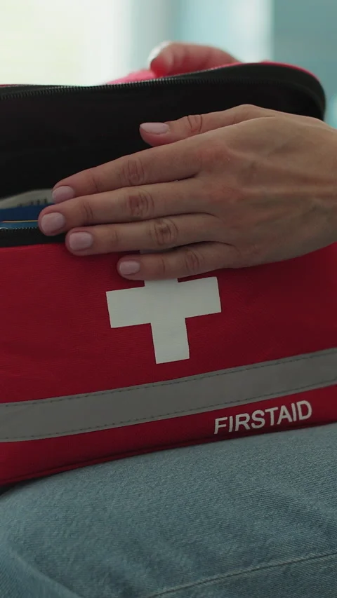 Vertical video Woman open the first aid kit at home. Life saving, medical care Stock Footage 338080939