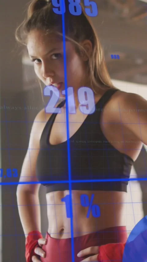 Vertical video: Woman pausing between sets resting in gym starting data showing Video stock 331050278