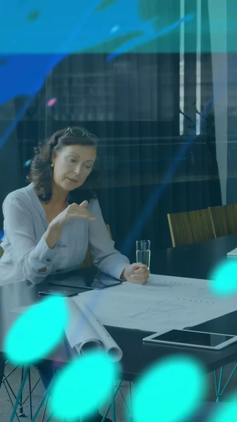 Vertical video: Woman pointing plans tapping tablet causing teal ticks over room Stock Footage 332775331