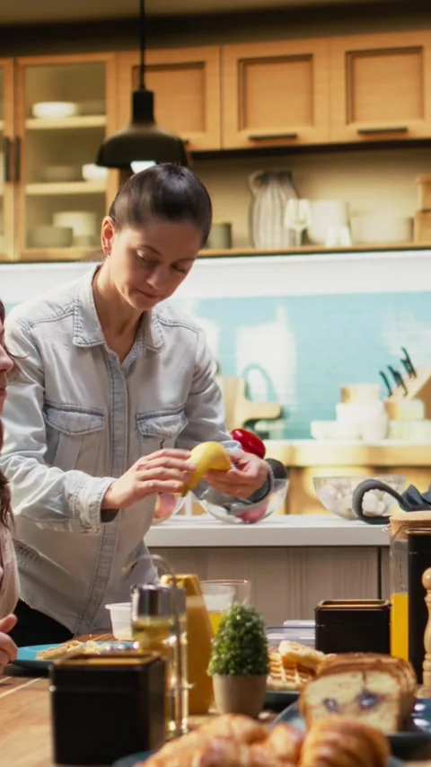 Vertical Video Woman preparing lunch box for her pre-teen school girl during Stock Footage 327098917