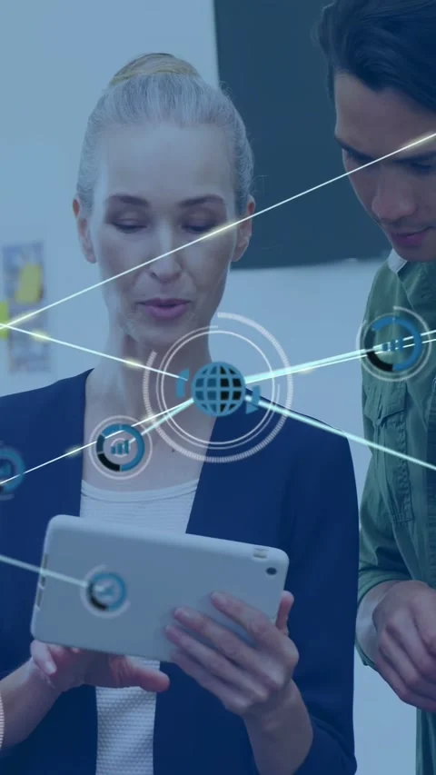 Vertical video: Woman presenter tapping tablet man leaning close causing AR node Stock Footage 333840069