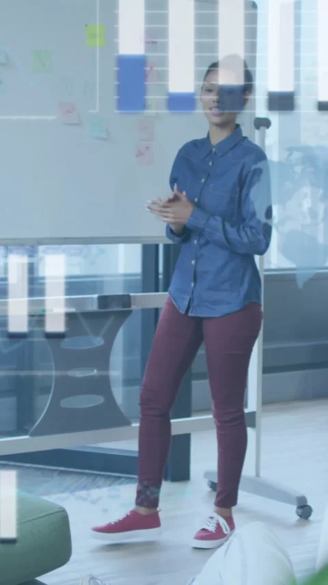 Vertical video: Woman reaching adding notes pointing while tech bars tracking Stock Footage 344693932