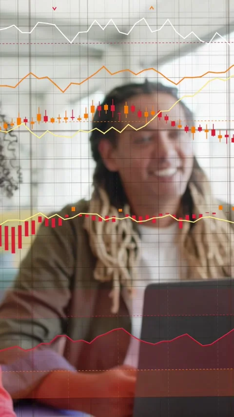 Vertical video: Woman in red pointing tablet causing live charts over devices Stock Footage 333541908