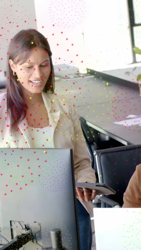 Vertical video: Woman sharing tablet data in office causing dots growing, hiding Stock Footage 332869200