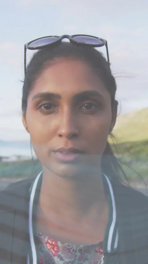 Vertical video: Woman smiling while camera zooming and lens flare sweeping face, Stock Footage 330430152