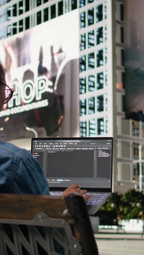 Vertical Video Woman software developer writing code on laptop and relaxing on Stock Footage 334200192