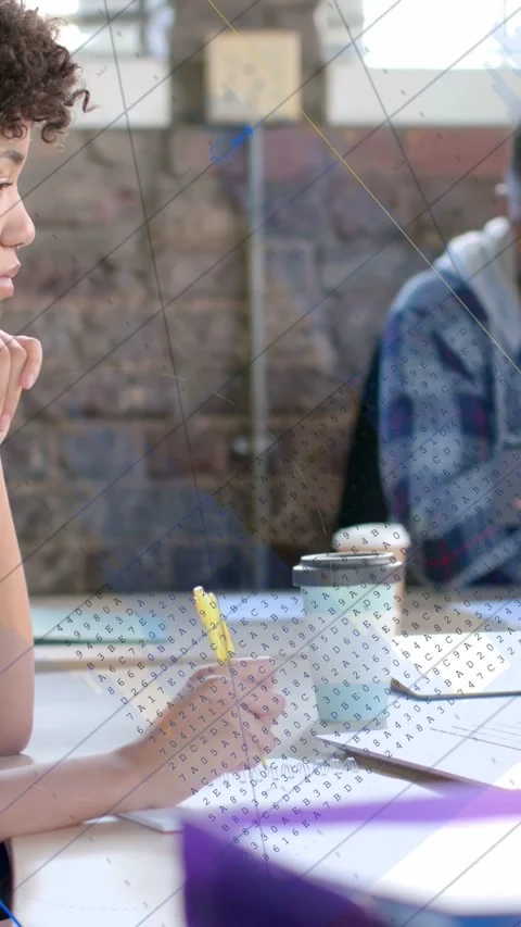 Vertical video: Woman taking notes, pen motion causing blue line chart Stock Footage 333236545