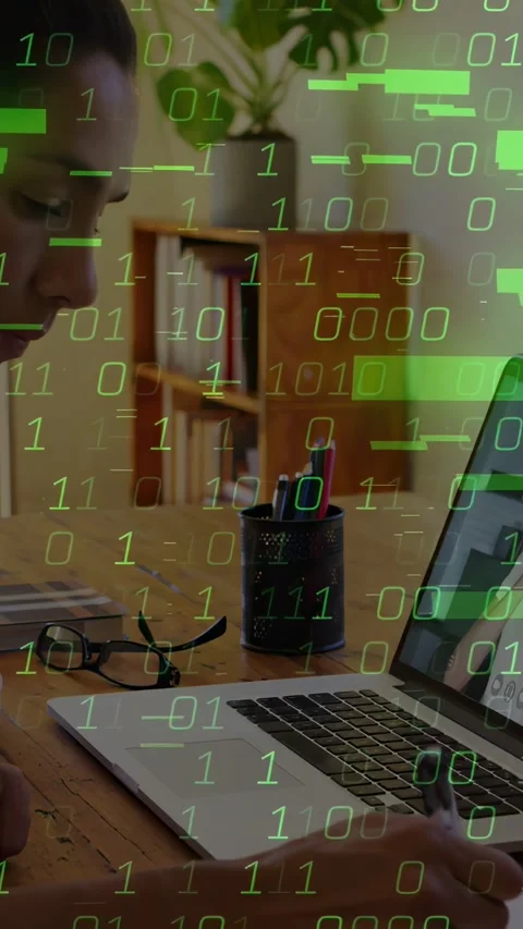 Vertical video: Woman taking notes, laptop causing green tech overlay growing, Stock Footage 334382007